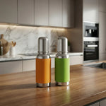 Load image into Gallery viewer, Two stainless steel thermos bottles with orange and green sleeves on a wooden kitchen countertop