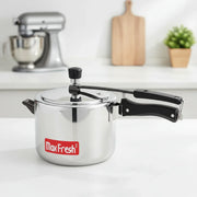 Max Fresh stainless steel pressure cooker with black handle on white kitchen counter