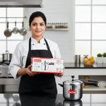 Load image into Gallery viewer, Chef in black apron holding Max Fresh Triply stainless steel pressure cooker box in modern kitchen