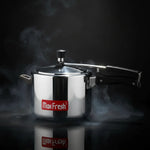Load image into Gallery viewer, Max Fresh stainless steel pressure cooker with black handle surrounded by steam on black background
