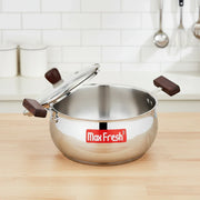 Stainless steel Max Fresh cooking pot with wooden handles and lid in modern kitchen