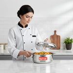 Load image into Gallery viewer, Chef lifting lid off steaming MaxFresh stainless steel pot with cooked vegetable rice in modern kitchen