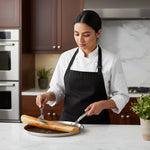 Load image into Gallery viewer, Chef in black apron making crispy dosa on non-stick tawa in modern kitchen