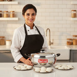 Load image into Gallery viewer, Happy chef holding Max Fresh stainless steel idli cooker with three plates of idlis in modern kitchen