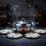 Load image into Gallery viewer, Steaming Max Fresh idli cooker with sandwich bottom and three plates filled with fresh idlis on black countertop