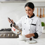 Load image into Gallery viewer, Chef pouring hot tea from VinFresh stainless steel saucepan into white cup in modern kitchen