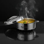 Load image into Gallery viewer, Steaming hot yellow lentil curry in a stainless steel MaxFresh container with partially open lid on black surface