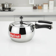 Stainless steel MaxFresh pressure cooker with black handle on white kitchen countertop