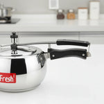 Load image into Gallery viewer, Stainless steel pressure cooker with black handle on white kitchen countertop