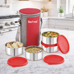 Stainless steel lunch box set with red lids and insulated bag on kitchen countertop