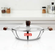 Max Fresh stainless steel kadai with glass lid and wooden handles on white kitchen counter