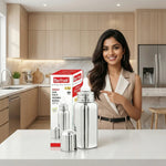 Load image into Gallery viewer, Smiling woman in beige outfit pointing at Max Fresh stainless steel baby feeding bottle in modern kitchen