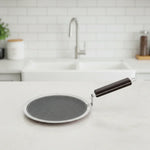 Load image into Gallery viewer, Round non-stick honeycomb roti tawa with black handle on white kitchen countertop
