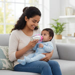 Load image into Gallery viewer, Mother feeding baby with stainless steel pink-handled baby feeding bottle on gray couch in bright room