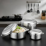 Load image into Gallery viewer, Set of three stainless steel casseroles with water droplets, one open with cooked rice, kitchen background