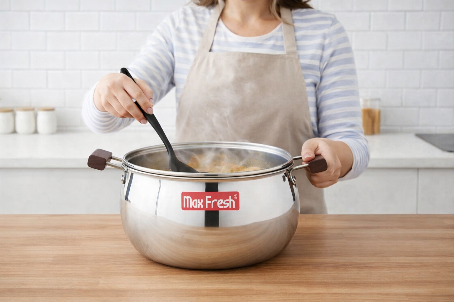 Woman stirring food in large stainless steel casserole pot on kitchen counter