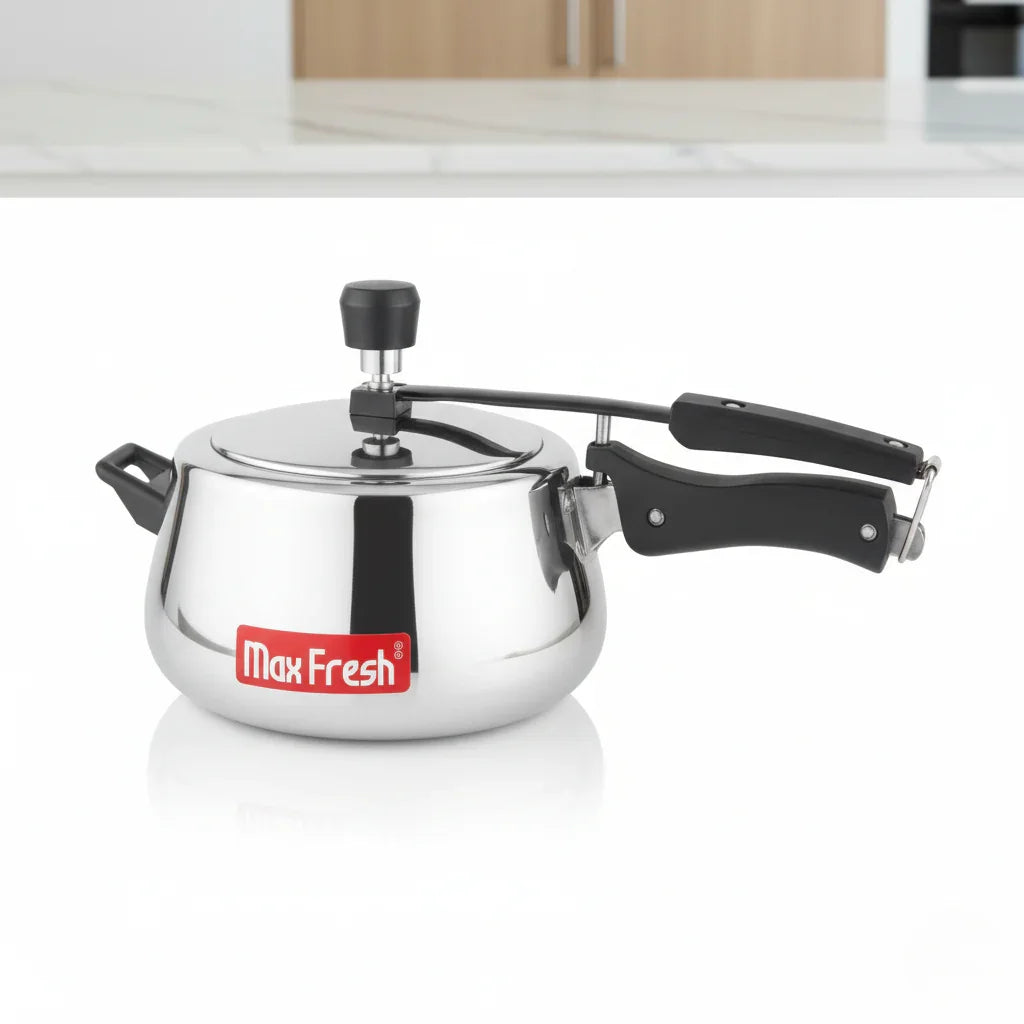 Stainless steel pressure cooker with black handles and MaxFresh label on white kitchen surface