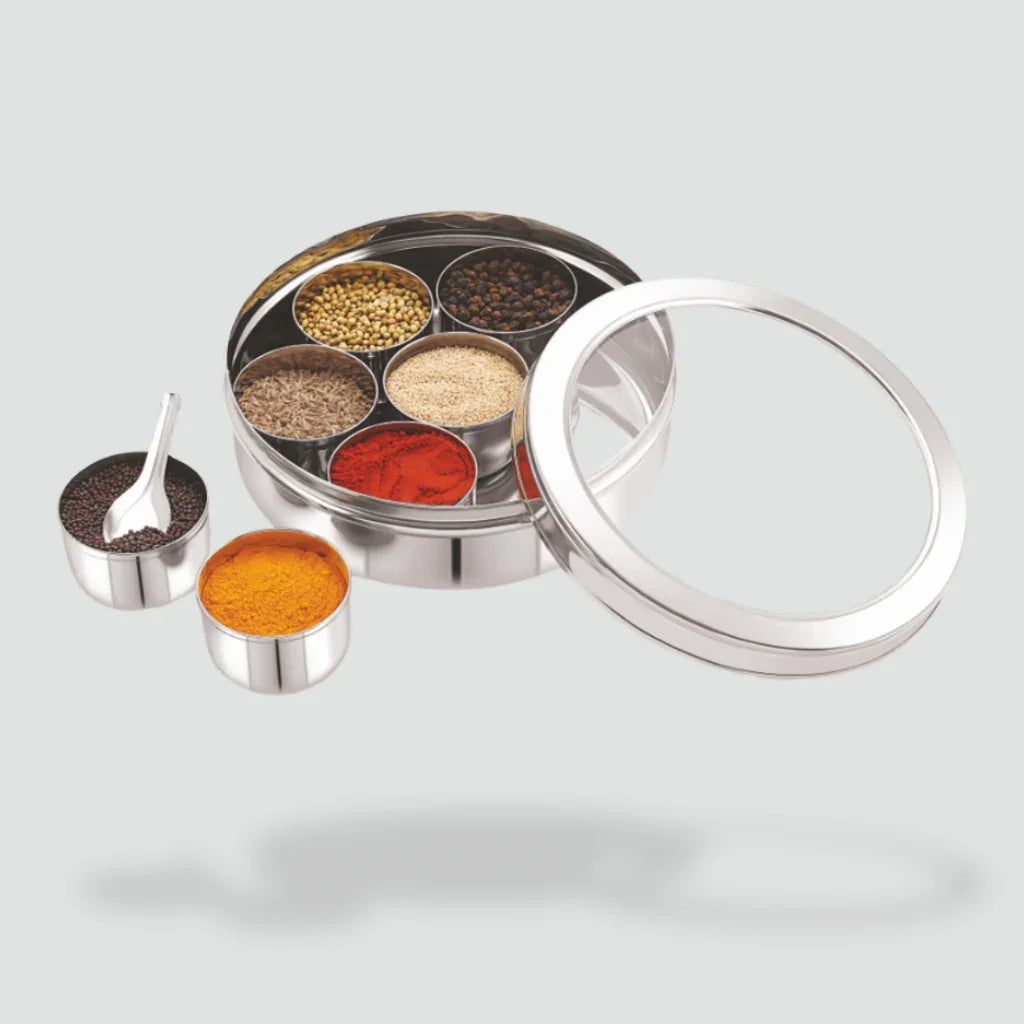 Stainless steel spice box with assorted spices and a clear lid for kitchen storage