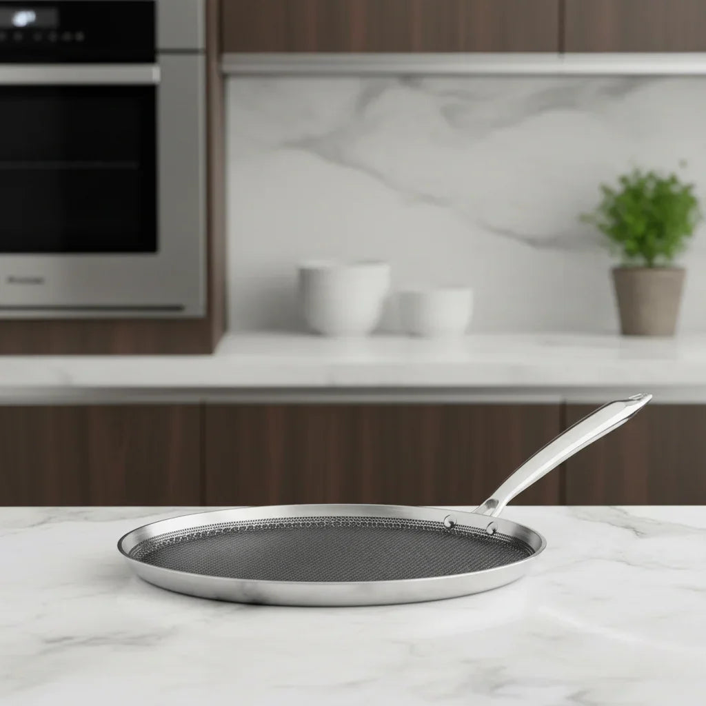 Stainless steel triply dosa tawa with honeycomb pattern on a modern kitchen counter