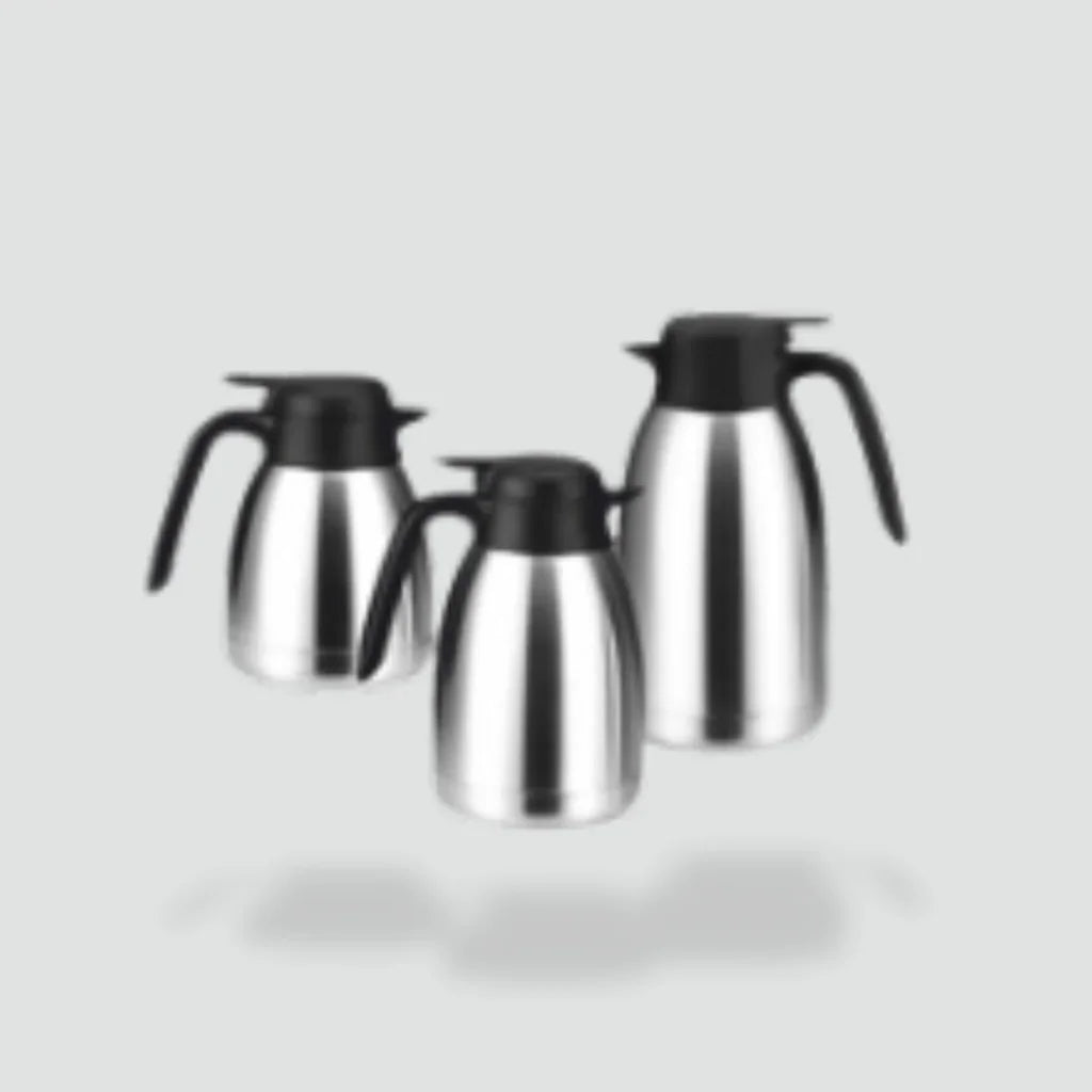 Set of three stainless steel coffee pots with black lids and handles on grey background