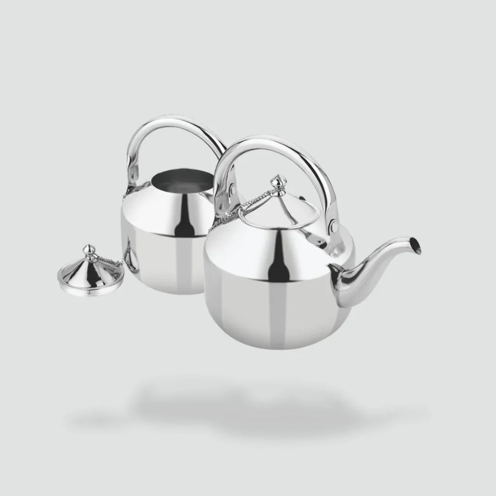 Stainless steel tea kettles with handles and spouts, one with lid removed, on light background.