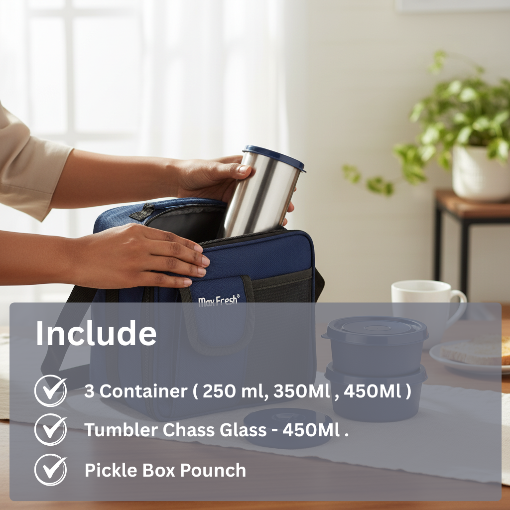 Stainless steel lunch box set with containers, tumbler, and pouch on a table, being packed into a blue insulated bag.
