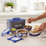 Stainless steel lunch boxes with blue lids, insulated lunch bag, and Indian food on table