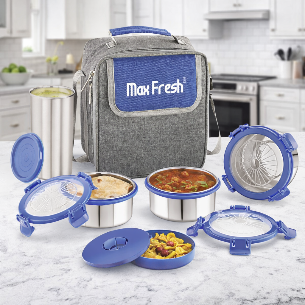Stainless steel lunch box set with blue lids and insulated bag on a kitchen counter