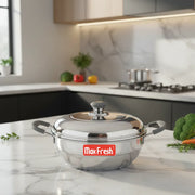 Stainless steel Max Fresh cooking pot with lid on marble kitchen counter surrounded by fresh vegetables