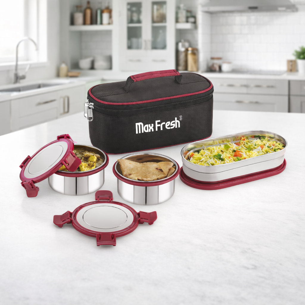 Stainless steel lunch box set with red lids and insulated carry bag on kitchen counter