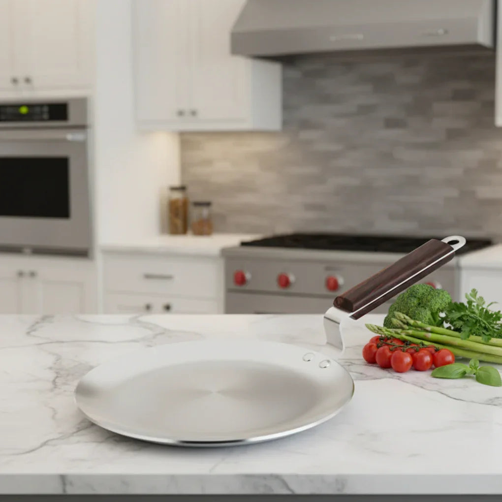Stainless steel tawa with wooden handle on kitchen counter next to fresh vegetables