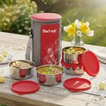 Stainless steel lunch box set with red lids and insulated carrier on outdoor table