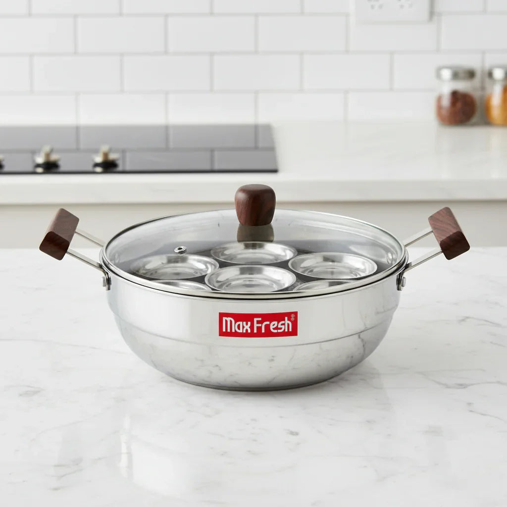 Triply stainless steel multi kadai with glass lid and wooden handles on kitchen counter
