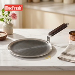 Stainless steel frying pan on a marble countertop with Max Fresh branding.