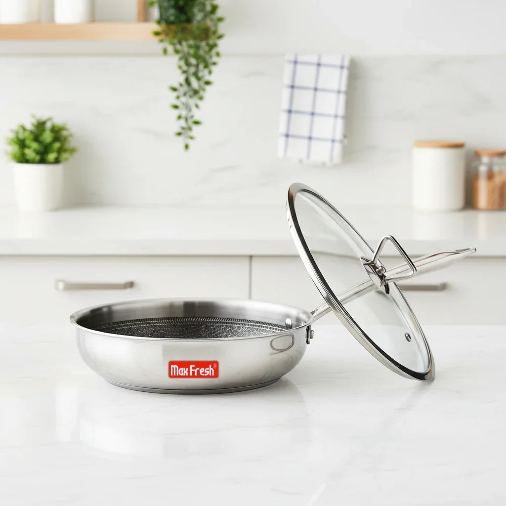 Stainless steel casserole with glass lid and mesh insert on kitchen counter