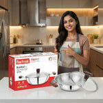 Load image into Gallery viewer, Smiling woman in kitchen pointing at Max Fresh Triply 20 cm steel kadai with glass lid and wooden handles