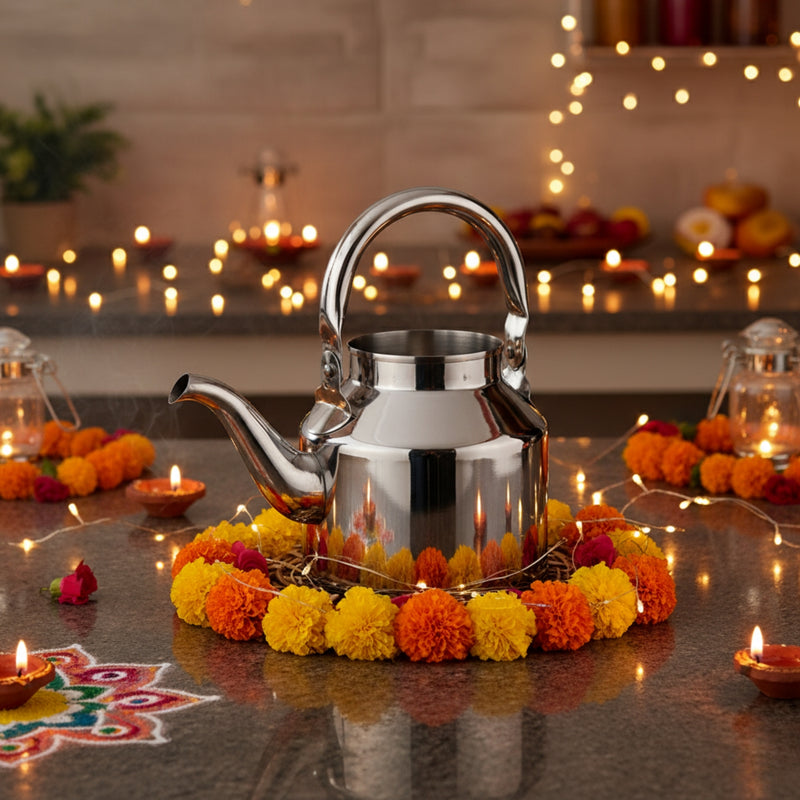 Silver teapot on a decorative setup with flowers and candles, likely for Diwali celebration.