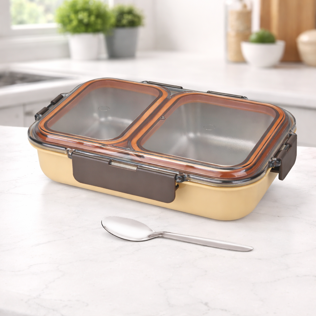 Stainless steel casserole with divided compartments and airtight lid on a kitchen countertop